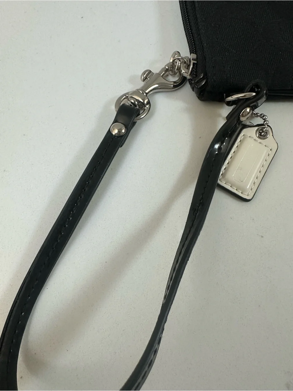 COACH Black Signature Wristlet with white coach tag